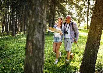 Couple hiking. Using map to get good direction.