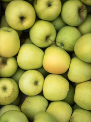 Background of green apples close up. Green apples pattern on sale at the market.