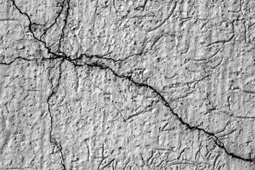 breaks in old cement and painted exterior wall