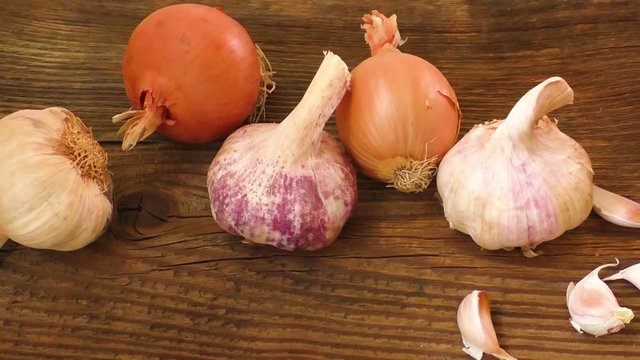 Garlic bulbs and onion on wooden board, natural medicine, eat healthy food

