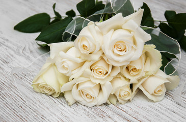 White roses on a wooden table