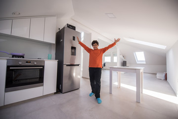 A boy standing in new modern kitchen