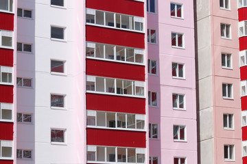 Part of new pink residential building with red balconies and dou
