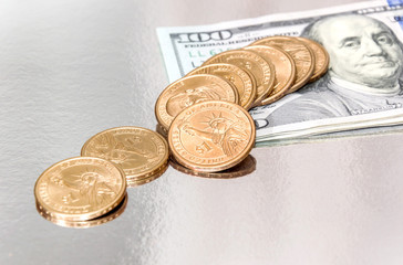 Hundred dollar bills with coins