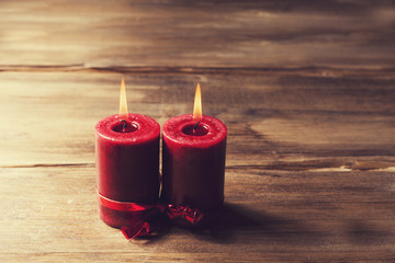 Two red candles tied with red ribbon, the symbol of Valentine's day, mimics the relationship of men...