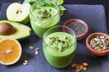 Fresh detox green smoothie with avocado, kiwi, salad with pumpki