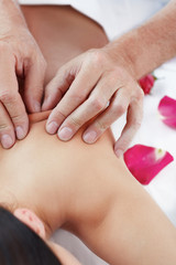 Beautiful woman receiving a relaxing back massage at spa.