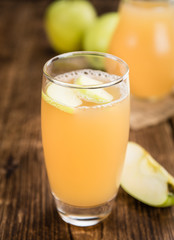 Fototapeta premium Fresh made Apple Juice on a rustic background