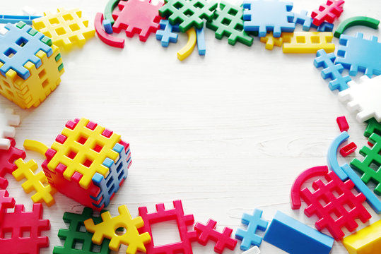 Colorful plastic interlocking pieces on white background