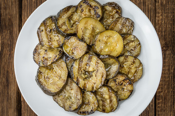 Zucchinis (grilled) on wooden background (selective focus)