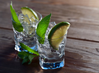 alcoholic drink with lime , ice and peppermint