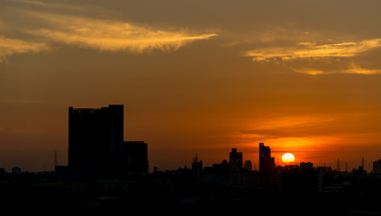 Fototapeta na wymiar Silhouette cityscape with orange sunrise sky