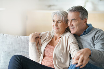Portrait of senior couple relaxing in sofa