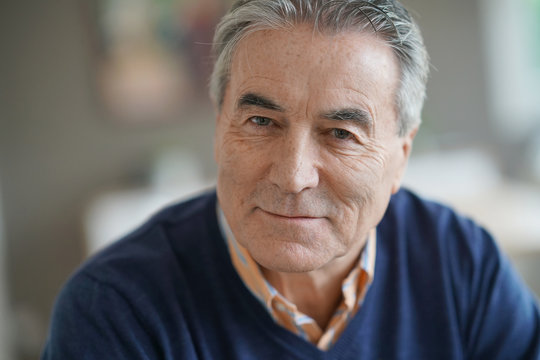 Portrait of senior man with blue sweater looking at camera