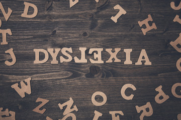 Word dyslexia on a wooden background - obrazy, fototapety, plakaty