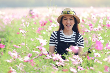 portrait of young beautiful girl a very happy in the flower cosmos field