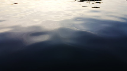 Water surface with ripples and sunlight reflections