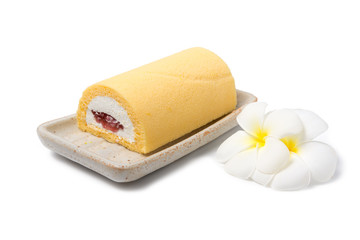 Roll cake with plumeria flowers on white background