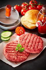 Uncooked raw hamburger patties with toppings