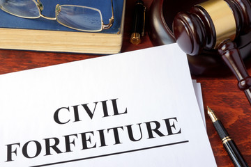Civil forfeiture, documents and gavel on a table.