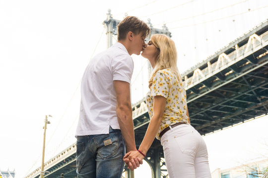 Young Couple in Love Visiting Brooklyn Bridge . New York City US