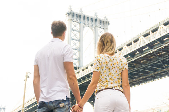 Young Couple in Love Visiting Brooklyn Bridge . New York City US