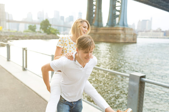 Young Couple Having Fun . Piggyback . New York City , Brooklyn 