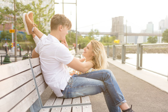 Young Goofy Couple Being Funny sitting on a Bench in Brooklyn . New York City