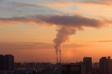 Smoke from industrial chimneys at dawn