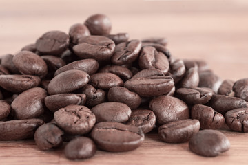 Closeup shot of dark brown, roasted coffee beans from colombia