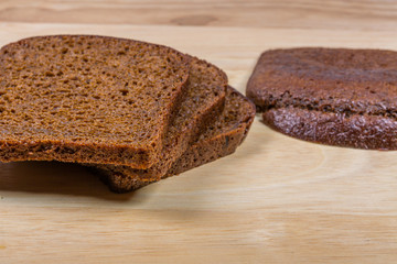 Pieces Of Sliced Brown Bread On Wood