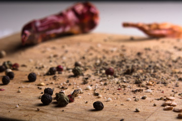 In kitchen chopping board ground pepper and peas