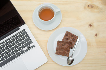 top view of brownie and tea cup on wooden table