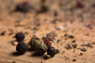 Close-up on a wooden board, ground pepper and peas
