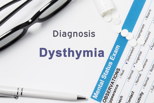 Diagnosis of Dysthymia. Results of mental status exam, container with crumbled pill with inscription psychiatric diagnosis Dysthymia on white background or white workplace psychiatrist or psychologist
