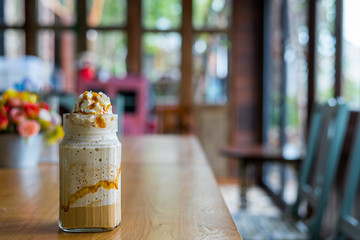 Blended coffe in the glass on table.