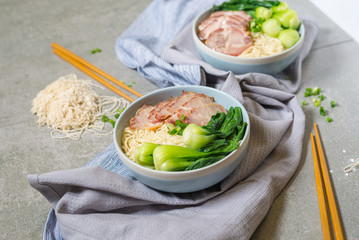 delicious egg noodle with red pork and vegetable in bowl decorat
