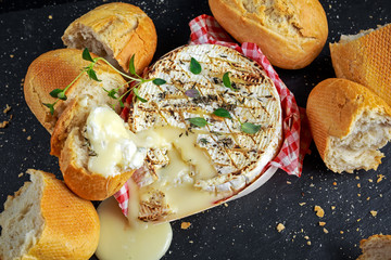 Homemade Baked Camembert cheese with thyme and fresh bread