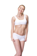 Obraz premium Young beautiful blonde woman in white fitness clothing