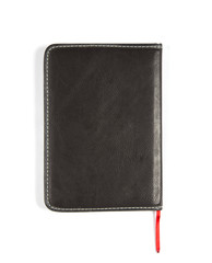 eyeglasses and notebook on wood background, black and white with