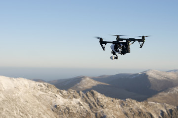 Fototapeta na wymiar A drone flying high in the mountains.