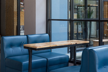 Empty wooden table and blue sofa restaurant