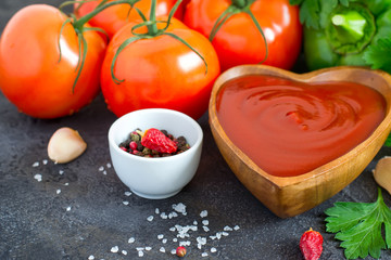 Wooden bowl with tomato ketchup and ingredients