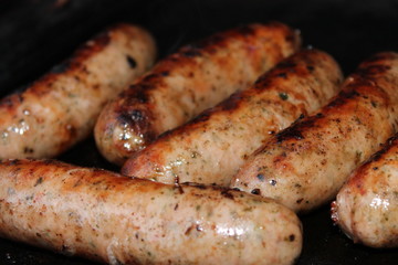 Sausages sizzling on a barbecue