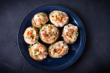 Baked stuffed potatoes with bacon, eggs and chives