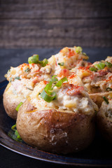Baked stuffed potatoes with bacon, eggs and chives