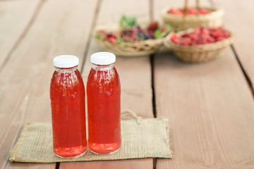 Two bottles of cold stewed fruit from assorted berries.