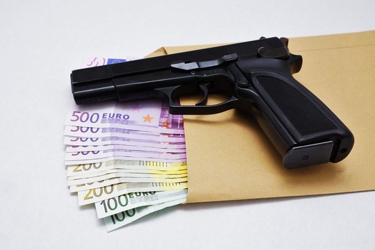 Pistol on euro banknotes