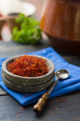 Raw Organic Red Saffron Spice in a clay bowl
