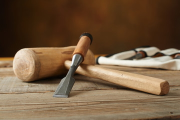 woodworking tolls, chisels and mallet on workbench